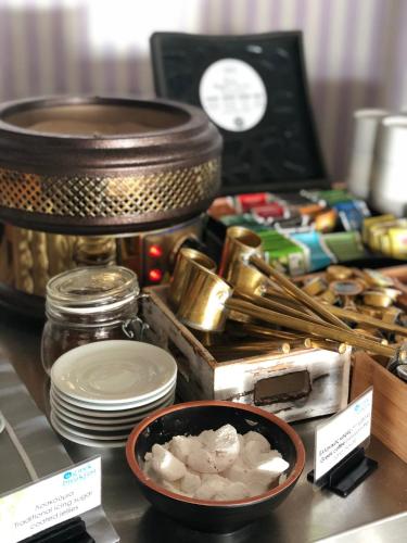 a table with a bowl of food and other items at Litohoro Olympus Resort Villas & Spa in Plaka Litochorou