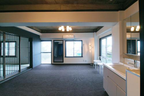 a large room with a kitchen and a living room at Famille Yukawa in Ito