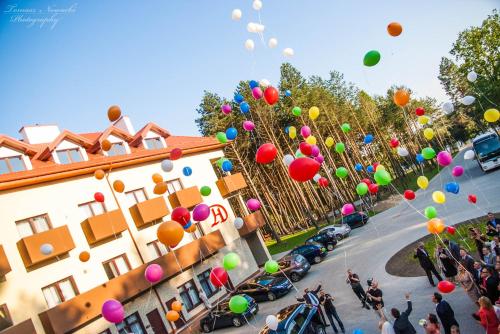 a bunch of colorful balloons flying over a street at Hotel Drohicki in Drohiczyn nad Bugiem