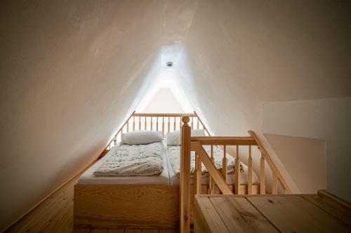 a bed in a room with a roof at Ferienwohnungen Finkenherd 5 in Quedlinburg