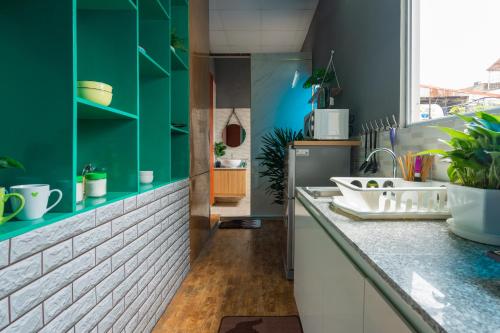 a kitchen with green cabinets and a white sink at KemKay CityView ✩3s to HKLake✩Big Balcony in Hanoi