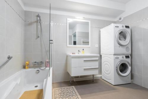 a bathroom with a washing machine and a washer at Residence Blue Harmony in Nice