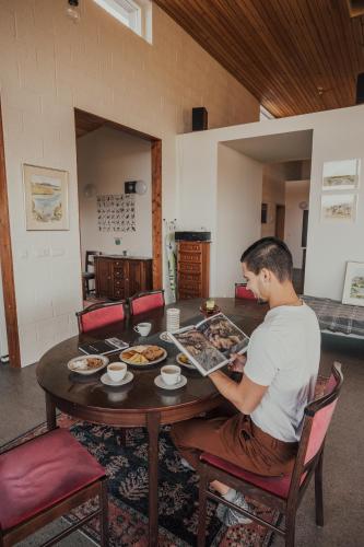 a man sitting at a table with food on it at Birkilauf in Myvatn