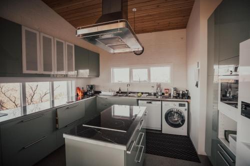 a kitchen with a sink and a stove top oven at Birkilauf in Myvatn