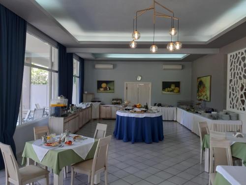 a banquet hall with tables and chairs in a room at Hotel Aethria in Limenas