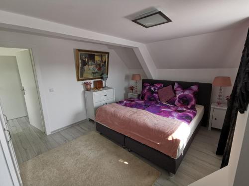 a bedroom with a purple bed with purple pillows at Wohnung am Stadtwald in Krefeld