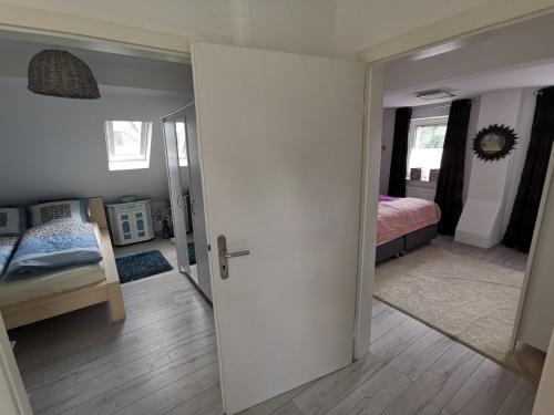 a room with a bedroom with a bed and a door at Wohnung am Stadtwald in Krefeld