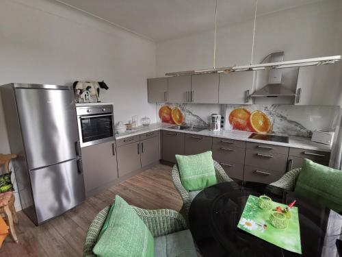 a kitchen with a stainless steel refrigerator and a table at Wohnung am Stadtwald in Krefeld