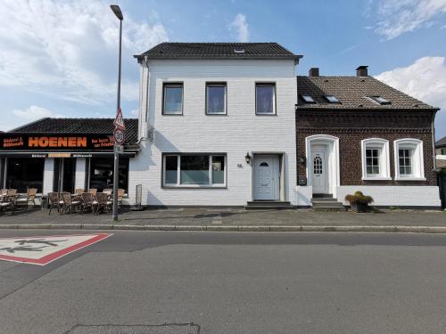 a white building on the corner of a street at Wohnung am Stadtwald in Krefeld