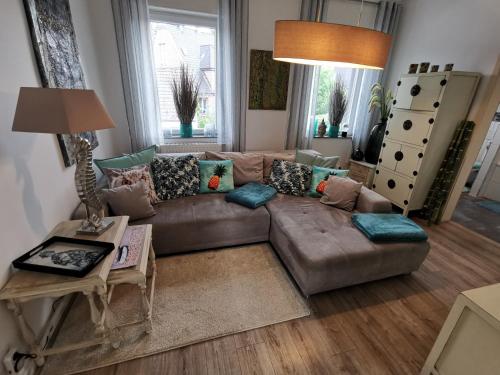 a living room with a couch and a table at Wohnung am Stadtwald in Krefeld