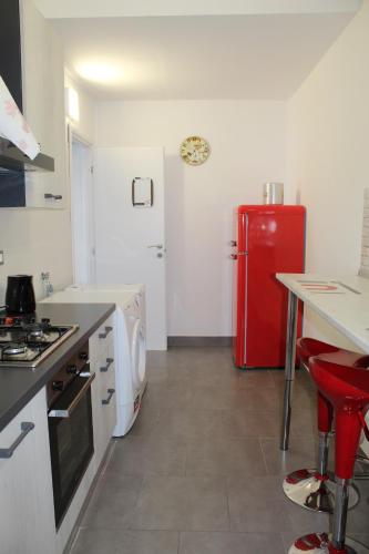 a kitchen with a red refrigerator and a counter at The Beach House in Lavagna