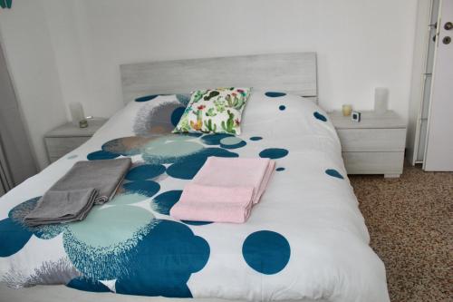 a bed with two towels and two pillows on it at The Beach House in Lavagna