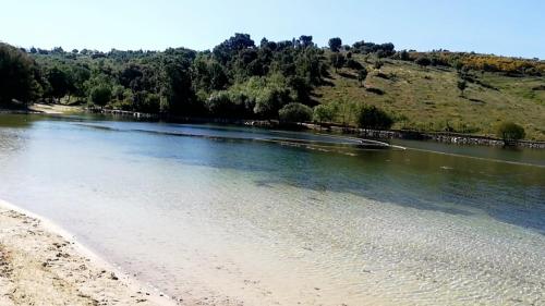 a view of a river with a beach and trees at Casa do Azibo in Santa Combinha