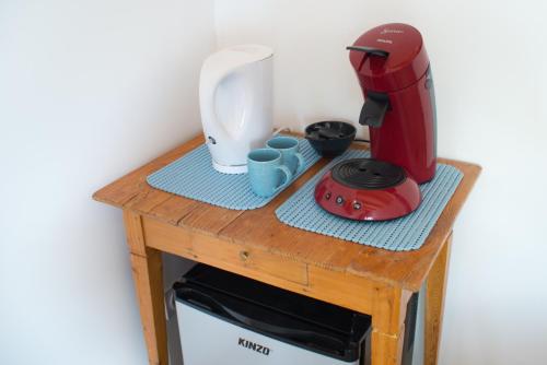 a table with a red blender on top of a microwave at villa d'illouvre in Saint-Chinian