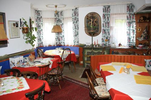 フルプメスにあるPension Edithのダイニングルーム(赤と黄色のテーブルクロス付きのテーブル付)