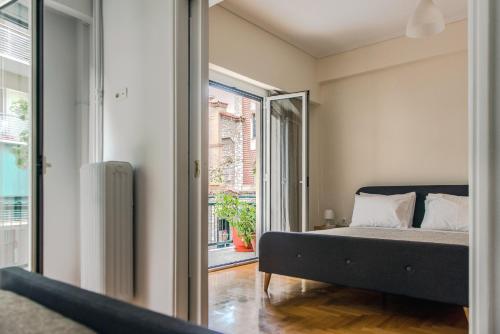 a bedroom with a bed and a window at Pnyka Apartment 2 in Athens