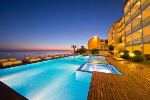 a large swimming pool next to a building at Yalihan Una in Avsallar