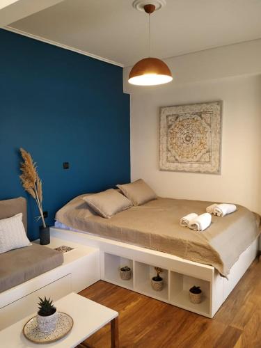 a room with a bed and a blue wall at Sealake View in Mesolongion