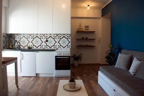 a living room with a couch and a kitchen at Sealake View in Mesolongion