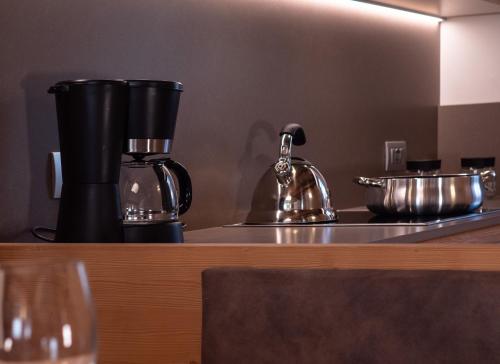 a counter top with a coffee maker and a mixer at Chalet Stella Alpina in Val di Zoldo