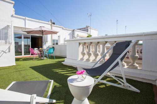 a balcony with a slide and a chair on the grass at Sky Touristic Attic in Valencia