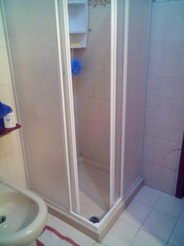 a shower in a bathroom with a sink at Max b&b in Valledoria