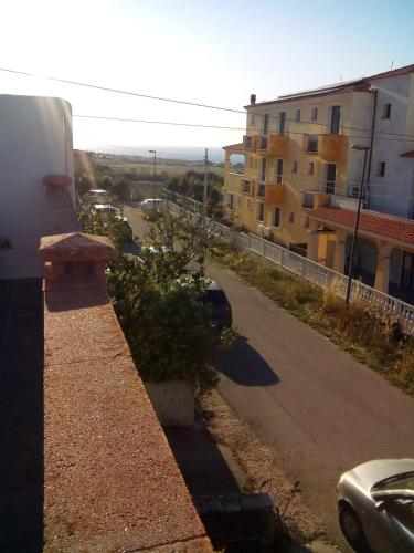 a view of a street with a building and a car at Max b&b in Valledoria