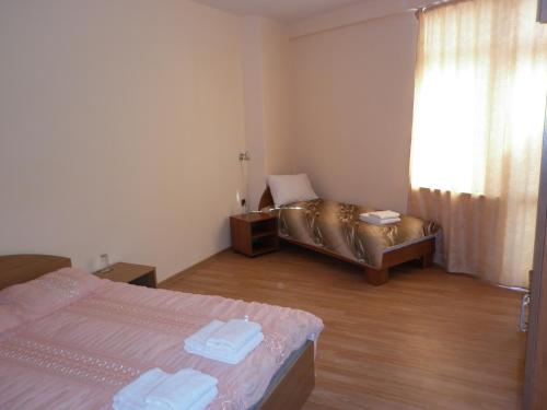 a hotel room with two beds and a couch at Ivanova Cheshma Guest House in Varna City