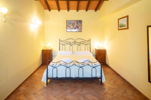 a bedroom with a bed and two night stands at Agriturismo Casale del Contadino in Bolsena