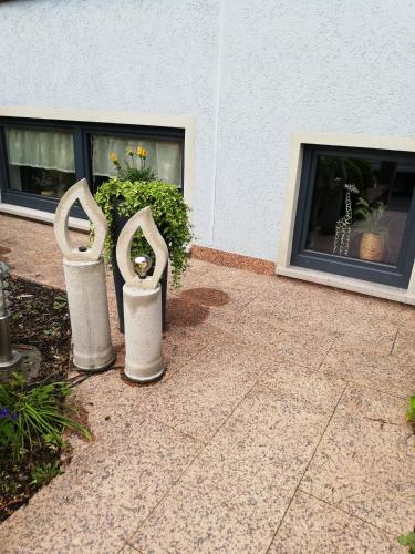 two trash cans sitting in front of a building at idylische Ferienwohnung in Schollbrunn