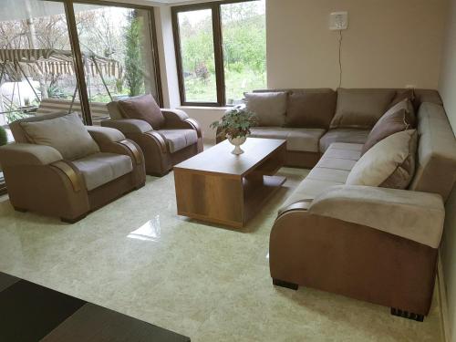 a living room with couches and a coffee table at The Kiwi House in Lagodekhi