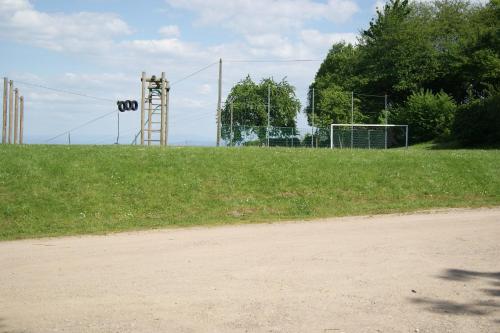 a dirt road next to a field with aoc sign at Le Divin Gîte Classé 4 étoiles in Hunawihr