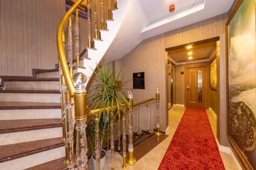 a hallway with stairs and a red carpet at Golden Sand Hotel in Istanbul