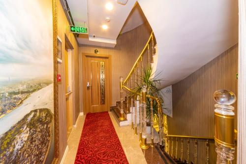 a hallway in a hotel with a red carpet at Golden Sand Hotel in Istanbul
