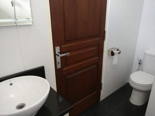 a bathroom with a white sink and a toilet at Dream Estate Resort in Senggigi 