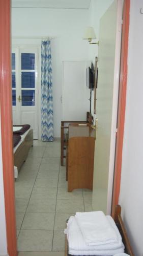 a room with a bed and a table in a room at Tatsis Apartments in Masouri