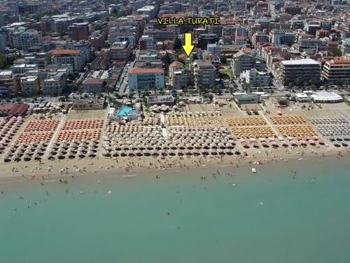 a view of a beach with a yellow arrow pointing to a city at Villa Turati in Pescara