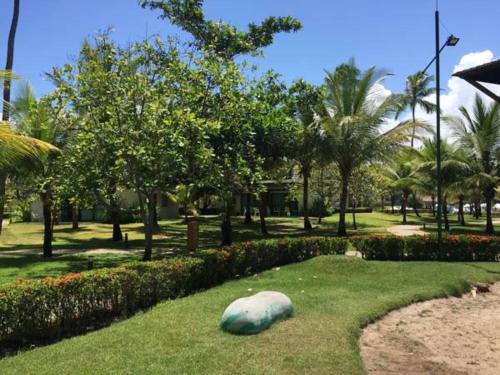 a large rock sitting on the grass in a park at Beach Class Resort 2 quartos Muro Alto BMS in Porto De Galinhas