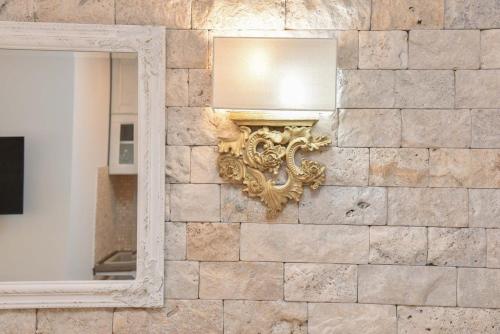 a mirror on a stone wall with a mirror on it at Old Town Skyline apartment 3 in Budva