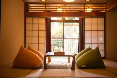 a room with a table in front of a window at The Ryokan Tokyo YUGAWARA in Yugawara