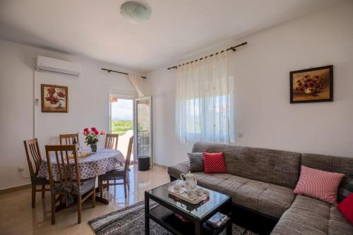 a living room with a couch and a table at Apartment Neretva dream in Komin