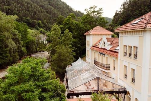 an aerial view of a building and a river at Gran Hotel Balneario De Puente Viesgo in Puente Viesgo