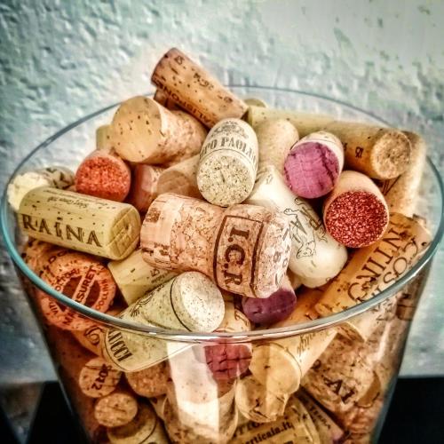 a glass bowl filled with different types of wine corks at Locanda Giustini in Assisi
