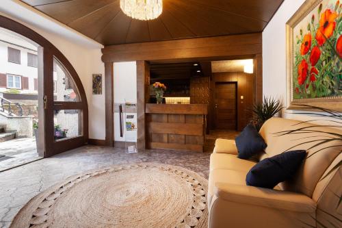 a living room with a couch and a counter at Hotel Petra in Baiersbronn