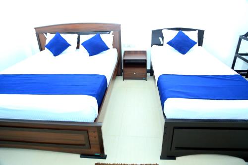 two beds sitting next to each other in a room at Blue Diamond Resort in Trincomalee