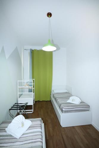 a room with two beds and a green wall at Unique luxury apartment and rooms in Rome