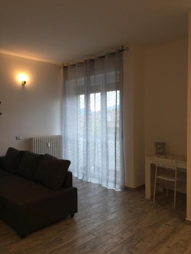 a living room with a couch and a window at La Gufetta in Varese