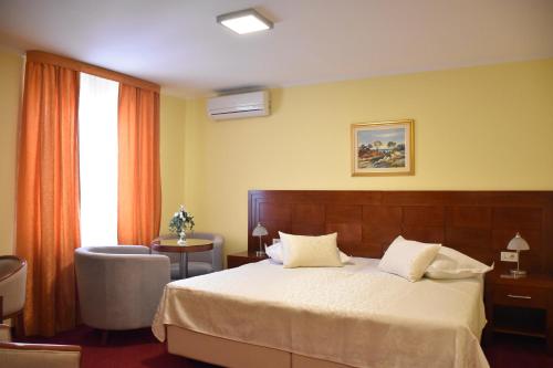 a hotel room with a bed and a window at Villa Riva in Makarska