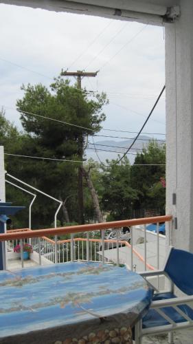 a balcony with a bed and a view of the ocean at Tatsis Apartments in Masouri