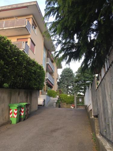 a building with two green trash cans in front of it at La Gufetta in Varese